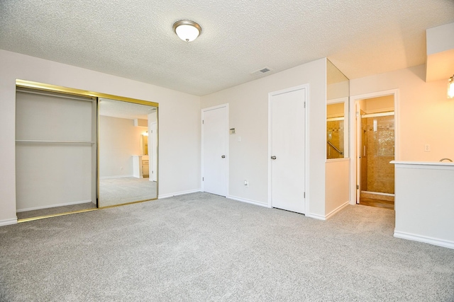 5001 Lamonte Ln Unit 14, Houston, TX 77092 - unfurnished bedroom featuring carpet, a closet, baseboards, and a textured ceiling
