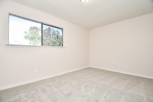 5001 Lamonte Ln Unit 14, Houston, TX 77092 - spare room featuring carpet flooring, baseboards, and a textured ceiling