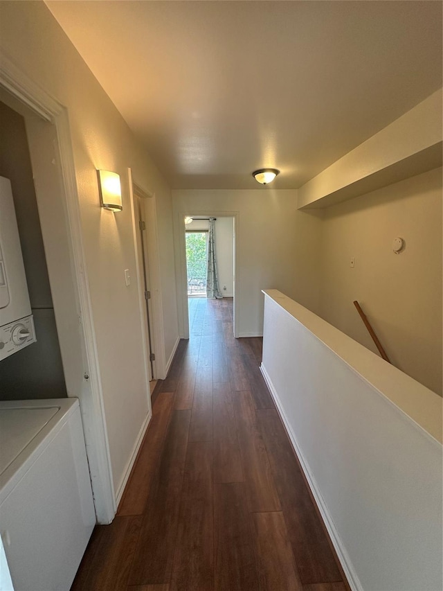9003 Gaylord St Unit 12, Houston, TX 77024 - hallway featuring estacked washer and dryer, an upstairs landing, and dark wood-style flooring