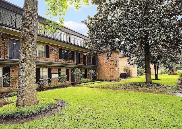 9003 Gaylord St Unit 12, Houston, TX 77024 - view of front facade with brick siding and a front lawn