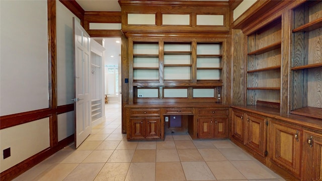 24615 W Kingscrest Cir, Spring, TX 77389 - unfurnished office with light tile patterned floors, built in desk, and baseboards