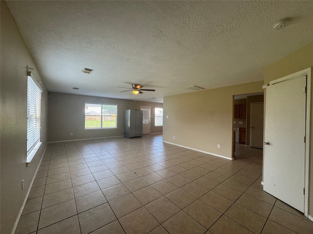 3406 Chateaucrest Ct, Houston, TX 77047 - empty room with tile patterned floors, baseboards, a textured ceiling, and a ceiling fan