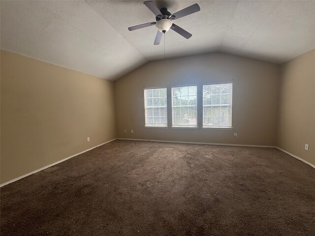 3406 Chateaucrest Ct, Houston, TX 77047 - empty room with lofted ceiling, dark carpet, ceiling fan, baseboards, and a textured ceiling
