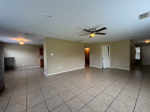 3406 Chateaucrest Ct, Houston, TX 77047 - unfurnished living room with light tile patterned flooring, a textured ceiling, baseboards, and ceiling fan