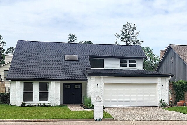 6658 Radley Dr, Spring, TX 77379 - view of front of home featuring concrete driveway, brick siding, a front yard, and an attached garage