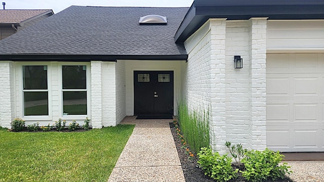 6658 Radley Dr, Spring, TX 77379 - view of exterior entry with roof with shingles, a garage, a lawn, and brick siding