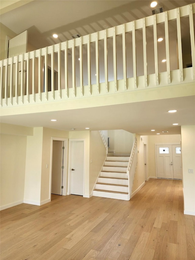 6658 Radley Dr, Spring, TX 77379 - stairs featuring a towering ceiling, wood finished floors, baseboards, and recessed lighting