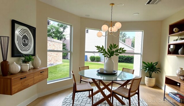 6658 Radley Dr, Spring, TX 77379 - dining area with light wood-type flooring, a chandelier, and baseboards