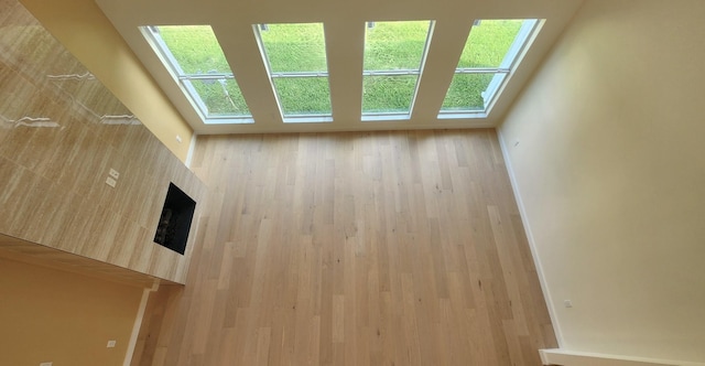 6658 Radley Dr, Spring, TX 77379 - unfurnished living room with a skylight and wood finished floors