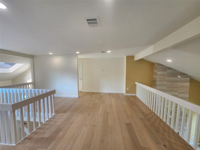 6658 Radley Dr, Spring, TX 77379 - hallway featuring a skylight, light wood-style floors, recessed lighting, an upstairs landing, and baseboards