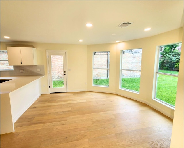 6658 Radley Dr, Spring, TX 77379 - kitchen featuring light wood-style flooring, recessed lighting, baseboards, tasteful backsplash, and light countertops