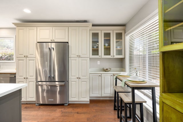 10718 Dunlap St, Houston, TX 77096 - kitchen featuring stainless steel appliances, light countertops, dark wood finished floors, glass insert cabinets, and recessed lighting