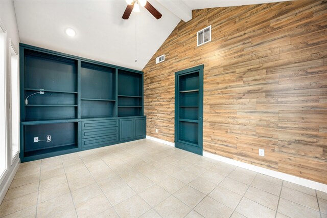 10718 Dunlap St, Houston, TX 77096 - empty room with wooden walls, a ceiling fan, built in shelves, beam ceiling, and light tile patterned floors