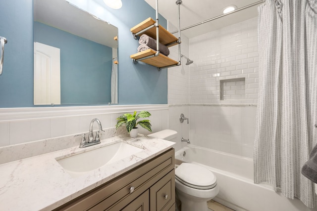 10718 Dunlap St, Houston, TX 77096 - bathroom featuring shower / tub combo with curtain, vanity, toilet, and a wainscoted wall