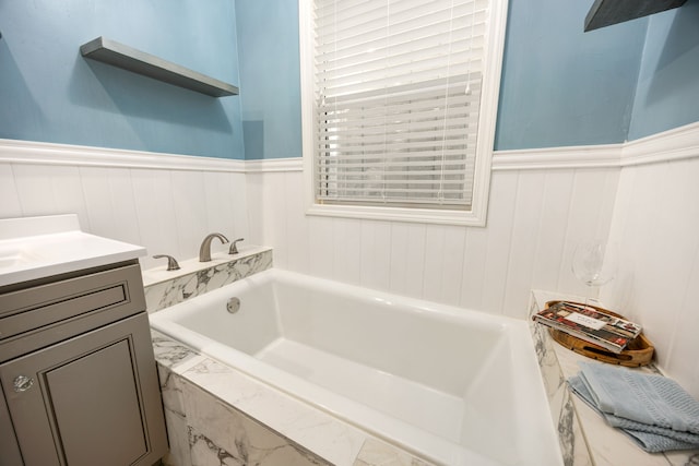 10718 Dunlap St, Houston, TX 77096 - full bath featuring a bath, vanity, and a wainscoted wall