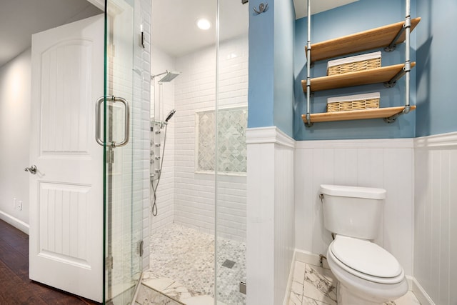 10718 Dunlap St, Houston, TX 77096 - bathroom featuring a stall shower, toilet, wainscoting, and baseboards