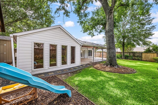 10718 Dunlap St, Houston, TX 77096 - rear view of house featuring a playground and a patio area