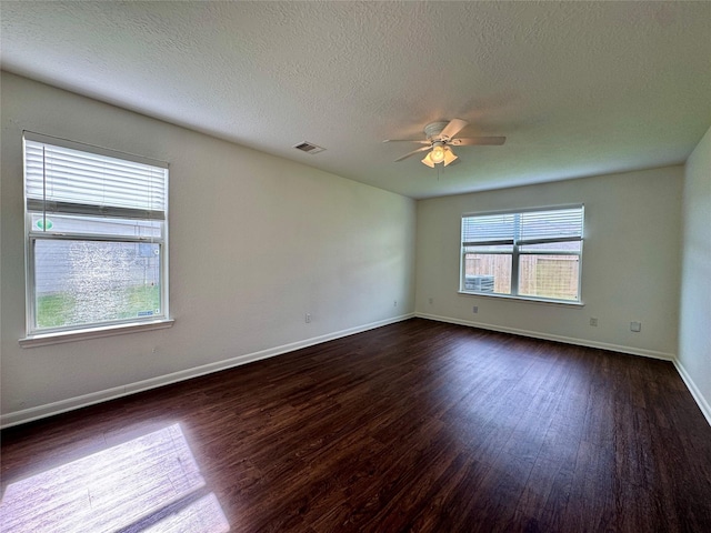 15507 Liberty Bluff Dr, Houston, TX 77049 - unfurnished room featuring dark wood finished floors, a ceiling fan, baseboards, and a textured ceiling