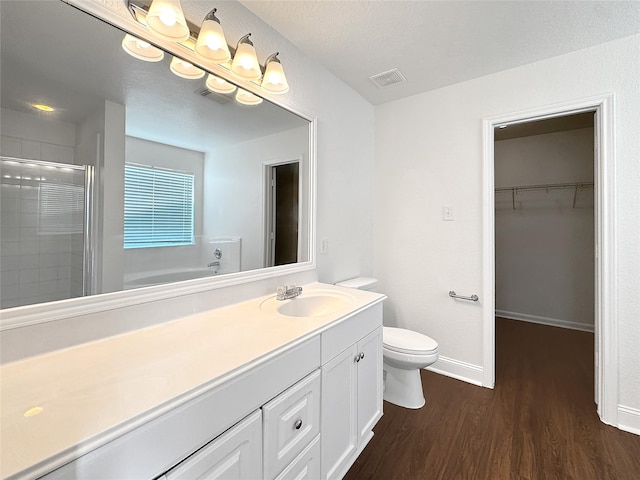 15507 Liberty Bluff Dr, Houston, TX 77049 - full bath featuring a shower stall, wood finished floors, vanity, a spacious closet, and a garden tub