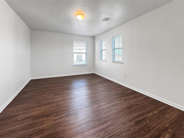 15507 Liberty Bluff Dr, Houston, TX 77049 - spare room featuring dark wood-style floors and a textured ceiling