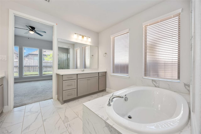 15711 Autumn Sun Ct, Conroe, TX 77302 - full bathroom with vanity, marble look tiles, a bath, and baseboards