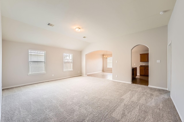 7607 Friesian Meadow Ln, Humble, TX 77338 - spare room with arched walkways, light colored carpet, baseboards, a chandelier, and a smoke detector