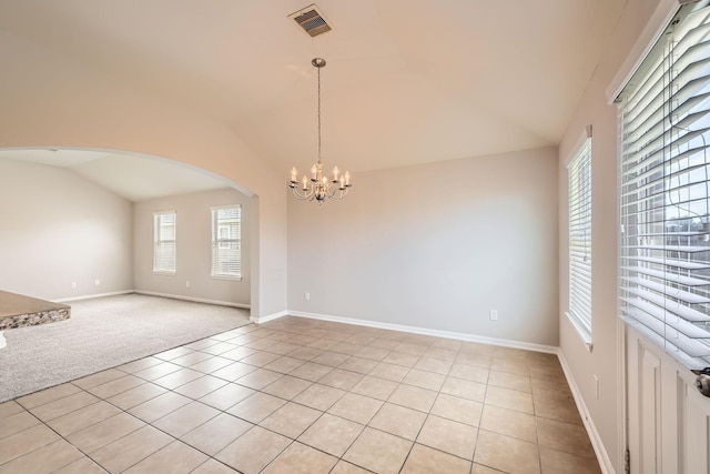 7607 Friesian Meadow Ln, Humble, TX 77338 - unfurnished room with vaulted ceiling, plenty of natural light, a chandelier, arched walkways, and light tile patterned flooring