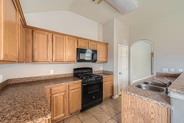 7607 Friesian Meadow Ln, Humble, TX 77338 - kitchen featuring black appliances, a sink, arched walkways, light tile patterned floors, and vaulted ceiling