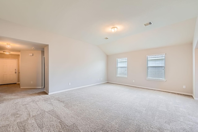 7607 Friesian Meadow Ln, Humble, TX 77338 - empty room with attic access, carpet flooring, baseboards, and vaulted ceiling