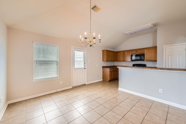 7607 Friesian Meadow Ln, Humble, TX 77338 - kitchen with black microwave, vaulted ceiling, a chandelier, brown cabinets, and light tile patterned floors