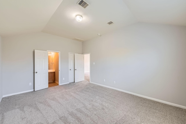 7607 Friesian Meadow Ln, Humble, TX 77338 - unfurnished bedroom with vaulted ceiling, carpet flooring, baseboards, and connected bathroom