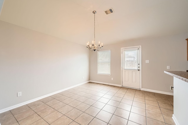 7607 Friesian Meadow Ln, Humble, TX 77338 - unfurnished dining area with a chandelier, light tile patterned floors, and baseboards