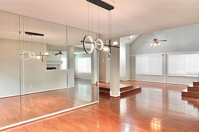 3114 Hollow Creek Ct, Houston, TX 77082 - unfurnished dining area with ceiling fan, wood finished floors, baseboards, vaulted ceiling, and stairway