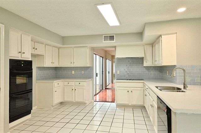 3114 Hollow Creek Ct, Houston, TX 77082 - kitchen with a sink, custom range hood, black appliances, tasteful backsplash, and light countertops