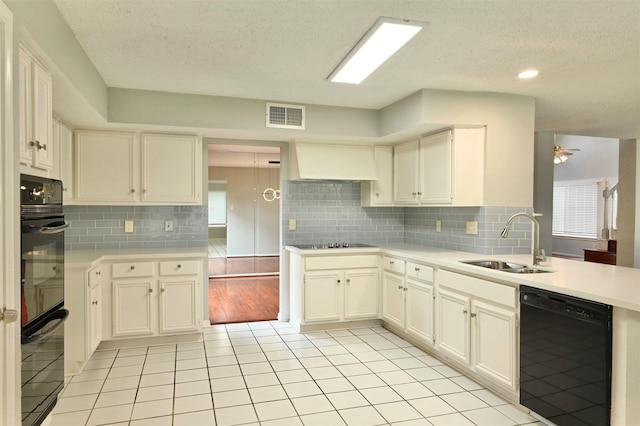 3114 Hollow Creek Ct, Houston, TX 77082 - kitchen with black appliances, a sink, premium range hood, healthy amount of natural light, and a textured ceiling