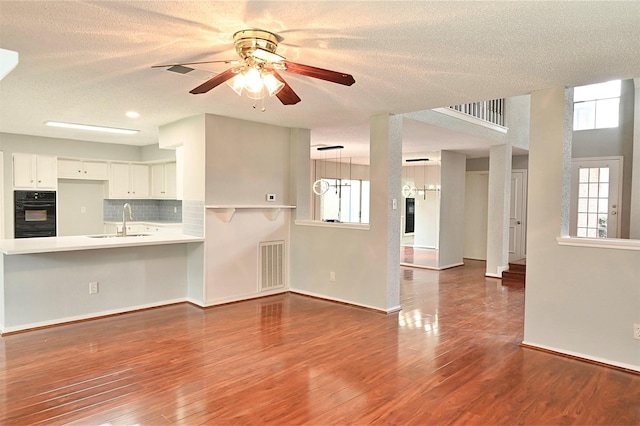 3114 Hollow Creek Ct, Houston, TX 77082 - unfurnished living room featuring a sink, a ceiling fan, wood finished floors, a textured ceiling, and baseboards