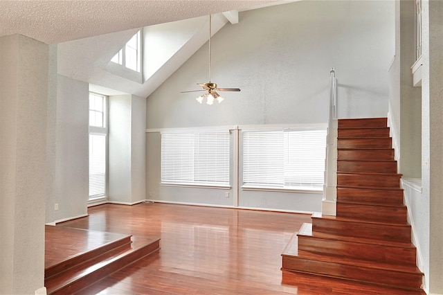 3114 Hollow Creek Ct, Houston, TX 77082 - unfurnished room featuring wood finished floors, stairway, a ceiling fan, high vaulted ceiling, and beamed ceiling