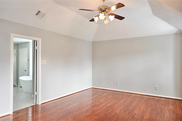 3114 Hollow Creek Ct, Houston, TX 77082 - spare room featuring ceiling fan, wood finished floors, lofted ceiling, baseboards, and a textured ceiling
