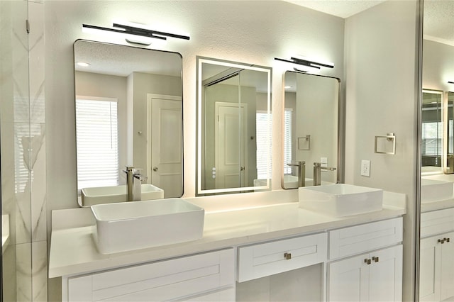 3114 Hollow Creek Ct, Houston, TX 77082 - bathroom with double vanity and a textured ceiling