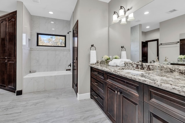 5912 T St, Katy, TX 77493 - bathroom featuring marble finish flooring, a bath, vanity, recessed lighting, and baseboards
