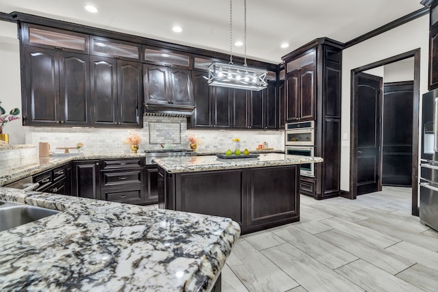 5912 T St, Katy, TX 77493 - kitchen with decorative backsplash, light stone counters, hanging light fixtures, stainless steel appliances, and a kitchen island