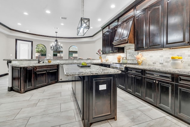 5912 T St, Katy, TX 77493 - kitchen featuring appliances with stainless steel finishes, a peninsula, premium range hood, a kitchen island, and tasteful backsplash