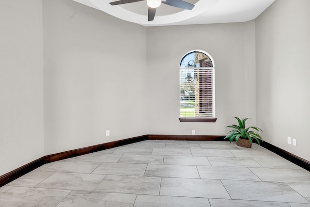 5912 T St, Katy, TX 77493 - unfurnished room with baseboards, ceiling fan, marble look tiles, and a tray ceiling