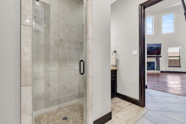 5912 T St, Katy, TX 77493 - full bathroom with a stall shower, a glass covered fireplace, baseboards, and vanity