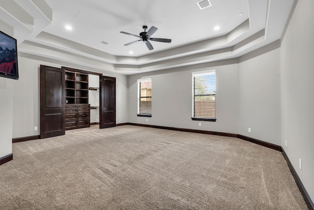 5912 T St, Katy, TX 77493 - unfurnished bedroom featuring a raised ceiling, light carpet, baseboards, a ceiling fan, and recessed lighting