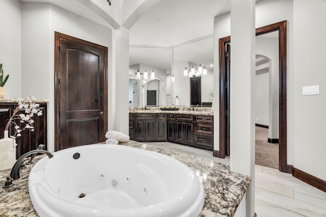 5912 T St, Katy, TX 77493 - bathroom featuring a whirlpool tub, vanity, and baseboards