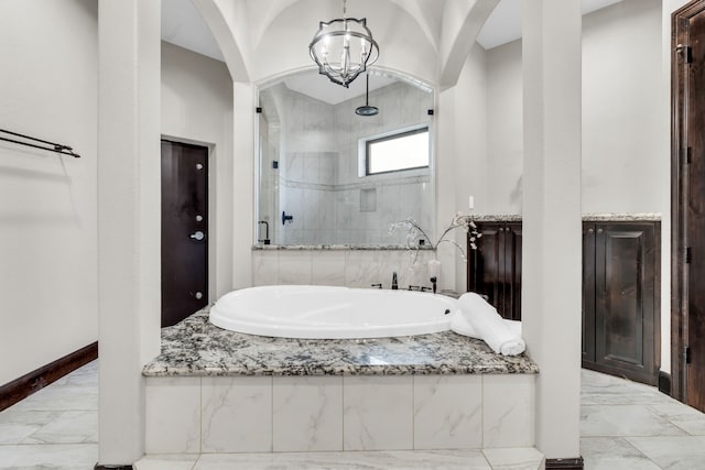 5912 T St, Katy, TX 77493 - full bathroom with marble tiled floors, a garden tub, and a stall shower