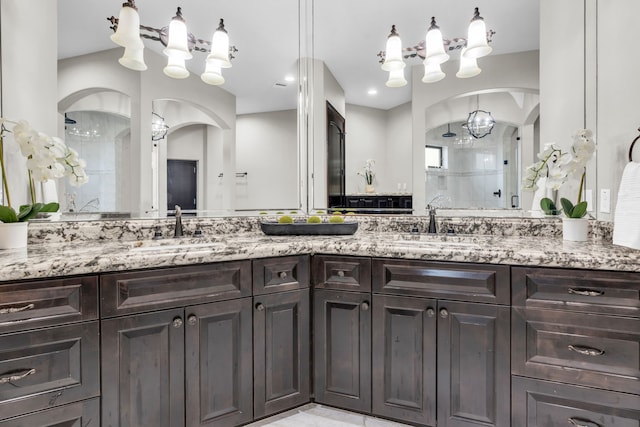 5912 T St, Katy, TX 77493 - full bath featuring a chandelier, a shower stall, and double vanity