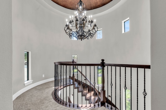 5912 T St, Katy, TX 77493 - staircase featuring a towering ceiling, carpet flooring, a chandelier, and baseboards