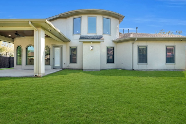 5912 T St, Katy, TX 77493 - rear view of house with a lawn, a ceiling fan, a patio, and stucco siding